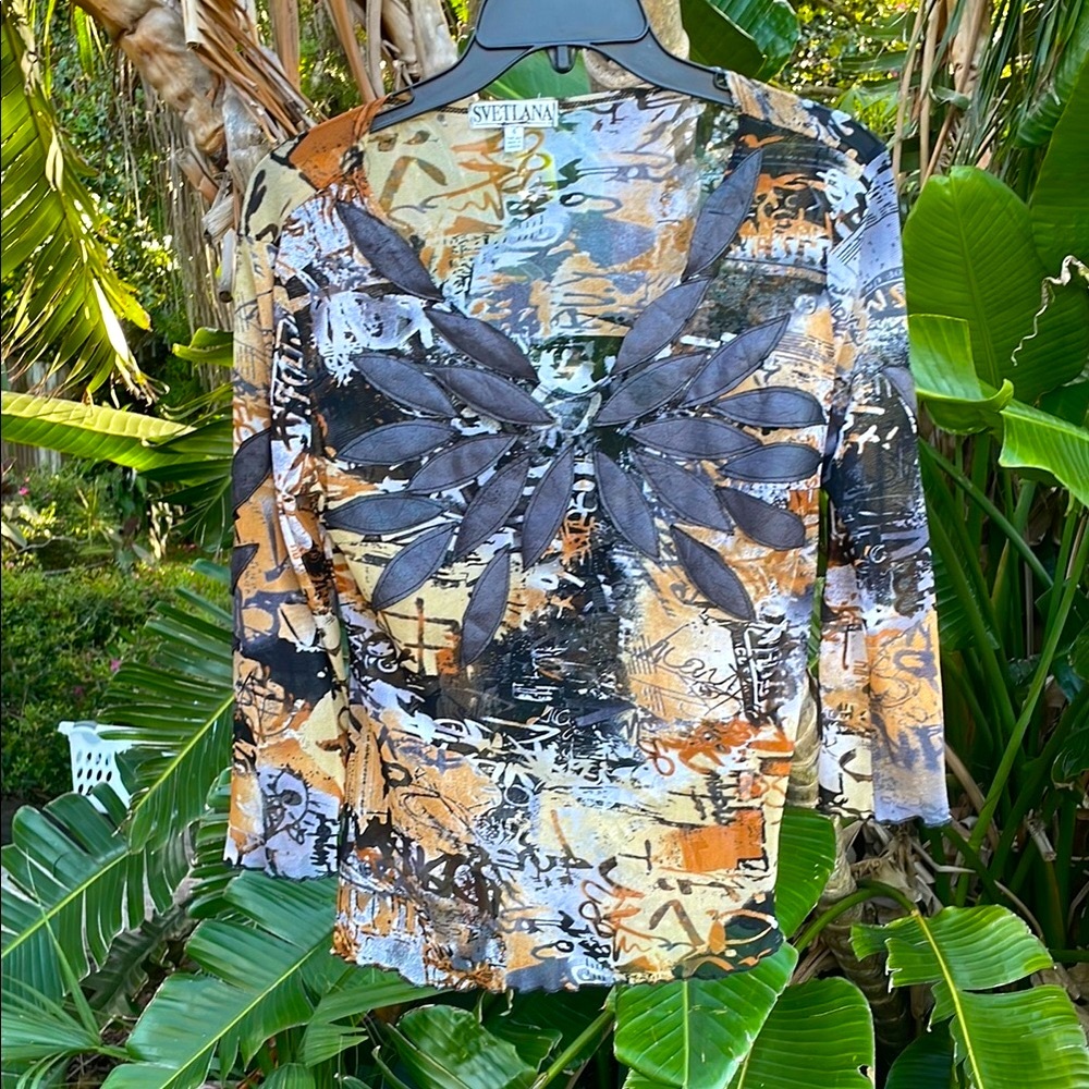sheer  mesh top with the leather leaf appliqué